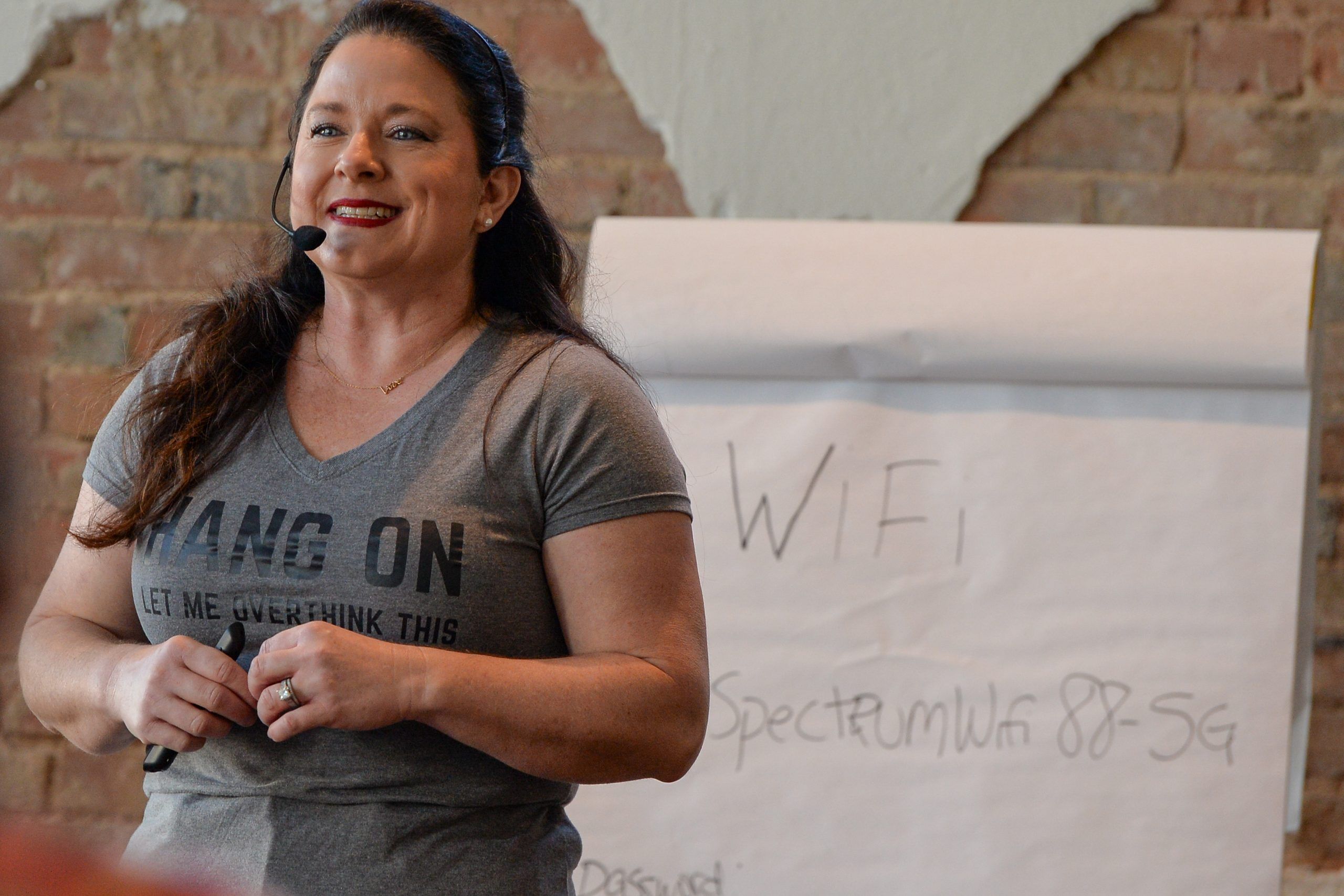 Chef Deb presenting beside a flip chart, headset mic on.